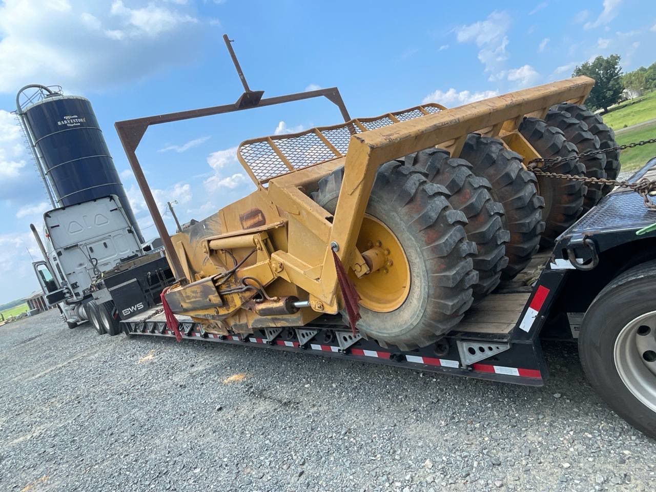 Heavy equipment loaded on specialized RGN trailer