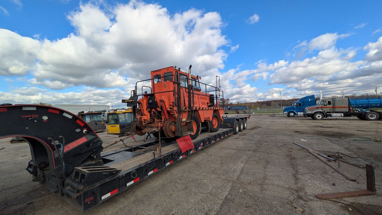 Vintage equipment loaded on flatbed trailer