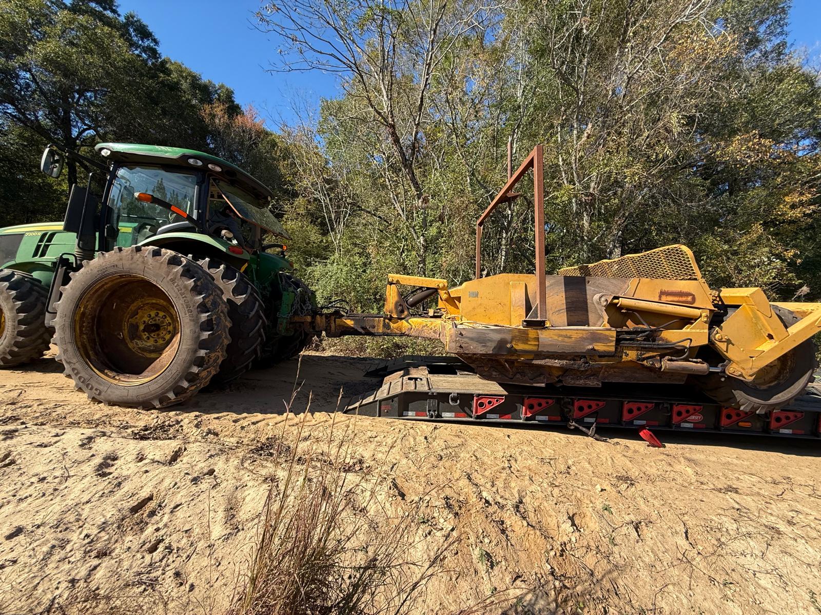 Tractor and roller secured on specialized trailer